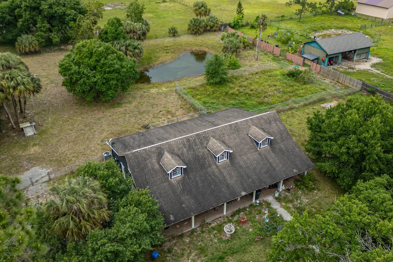 The ranch home with its old, weathered shingle roof